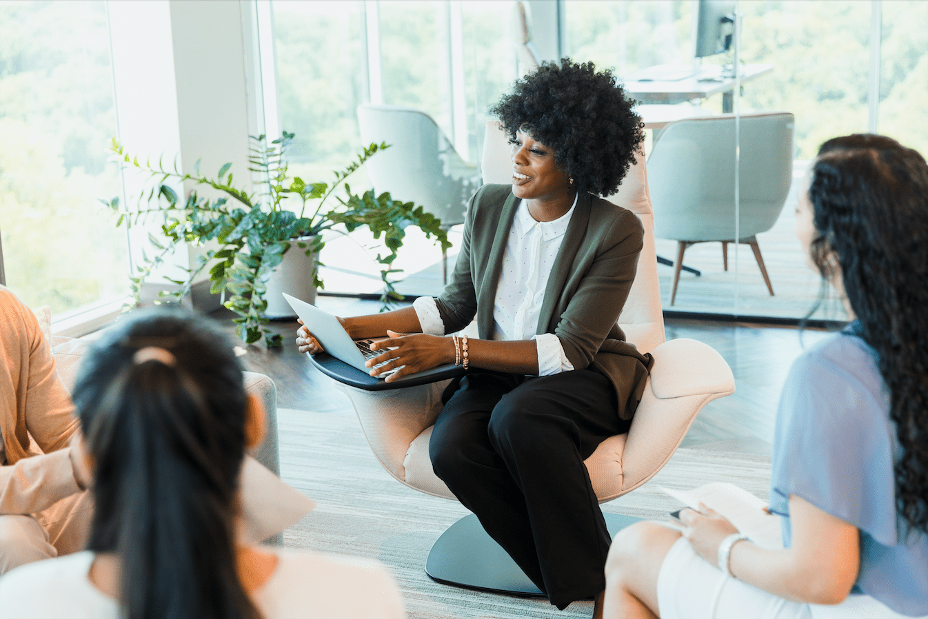 Femme influente et élégante assise au travail prenant la parole en réunion, utilisant sa voix et sa présence pour convaincre - femme influente élégante - Première Impression